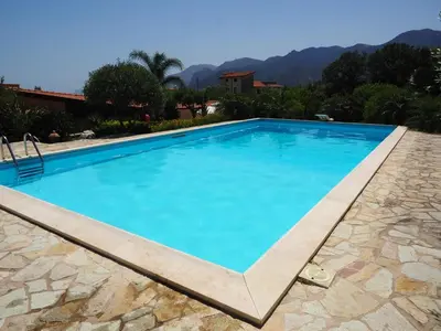 a large swimming pool with blue water at B&B Al Giardino in Monreale