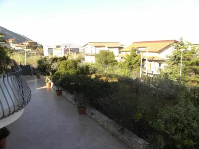 a courtyard with plants and buildings in a city at B&B Al Giardino in Monreale