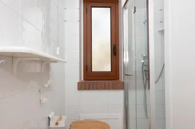 a bathroom with a shower and a mirror at Casa Ponente con Vista Mare a Macari in Macari