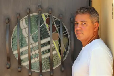 a man standing in front of a wall with a window at Donna Lia in Bagheria
