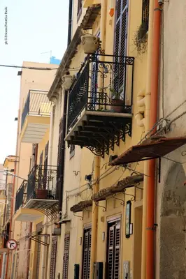 a group of buildings with balconies on a street at Donna Lia in Bagheria