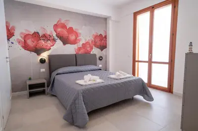 a bedroom with a bed with two towels on it at Residence Marinella in San Vito lo Capo