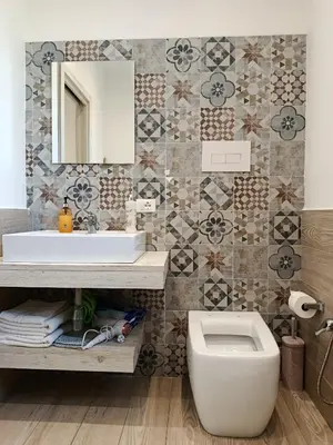 a bathroom with a toilet and a sink and a mirror at Sicily Rooms Appartamenti in Carini