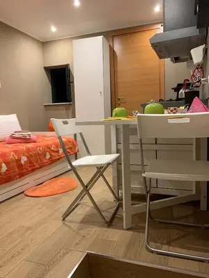 a kitchen with a table and a table and chairs at Casa Rosina in Palermo
