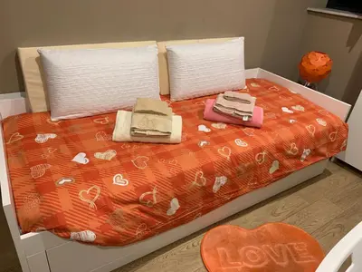 a bed with two pillows and towels on it at Casa Rosina in Palermo