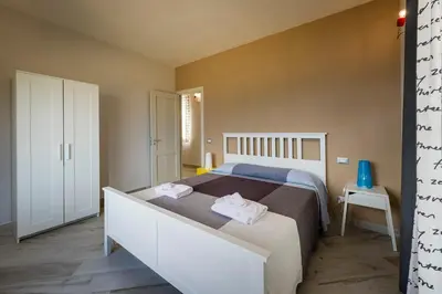 a bedroom with a bed with two towels on it at Villa Rosaria vicino la Riserva dello Zingaro in Scopello