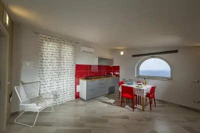 a house on the beach with the ocean in the background at Villa Rosaria vicino la Riserva dello Zingaro in Scopello
