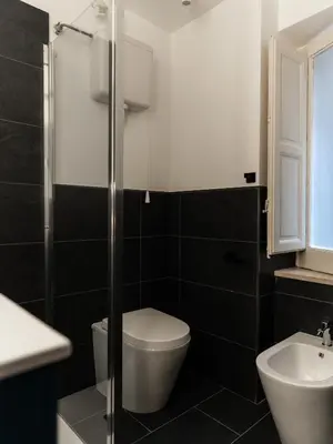 a bathroom with a toilet and a sink at Casa in centro in Palermo