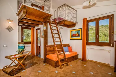 a room with a bunk bed and a ladder at APT Villa Anna e APT Cantina Vito vicinissimi alla Riserva dello Zingaro in Scopello