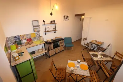 an aerial view of a living room with tables and chairs at Torre's Camere & caffè in Monreale
