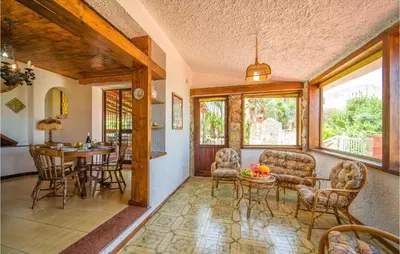 a living room with a table and chairs at Awesome Home In Trabia With Wifi in Trabia