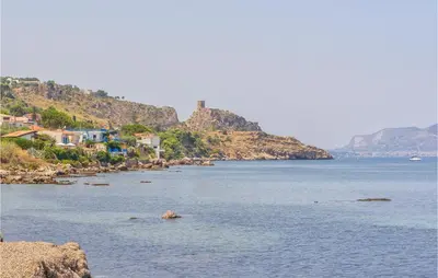 a large body of water with houses and a mountain at Awesome Home In Trabia With Wifi in Trabia