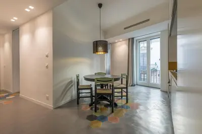a dining room with a table and chairs at Casa La Pomelia in Palermo