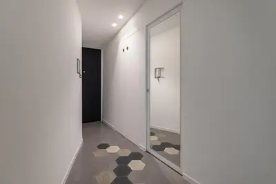 a hallway with a glass door and a tile floor at Casa La Pomelia in Palermo