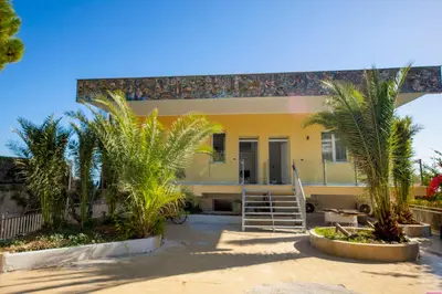 a house with palm trees in front of it at Villa Francesca 30 Pax by Ville in Palermo in Casteldaccia