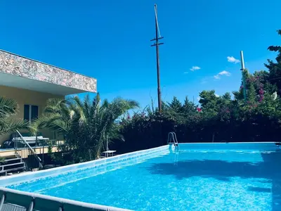 a swimming pool in front of a house at Appartamento 8 Pax in Villa Francesca by Ville in Palermo in Casteldaccia