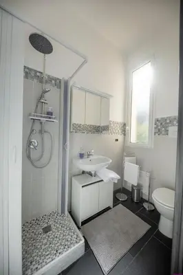 a white bathroom with a sink and a toilet at Appartamento 16 Pax in Villa Francesca by Ville in Palermo in Casteldaccia