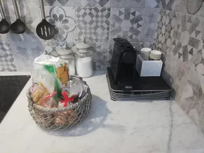 a kitchen counter with a basket of food and a toaster at Home 3L in Palermo