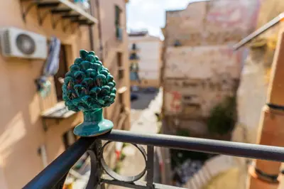 a green object on top of a metal railing at Khalisah in Palermo