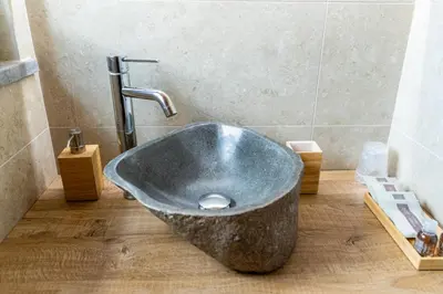 a bathroom with a stone sink in the floor at Khalisah in Palermo