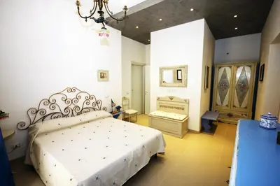 a bedroom with a white bed in a room at Khalisah in Palermo