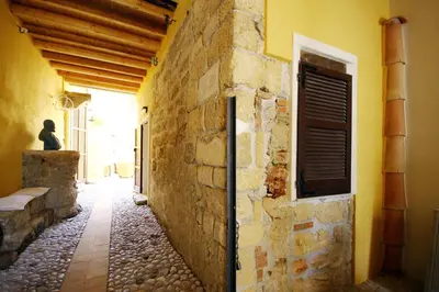 an alley in an old stone building with a window at Khalisah in Palermo