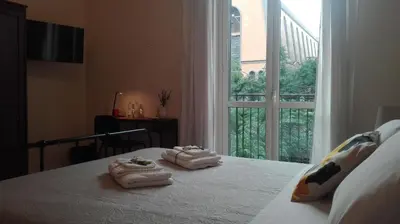 a bedroom with a bed with towels on it with a window at 