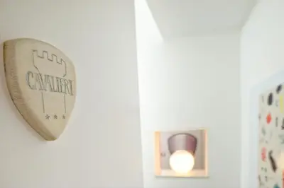 a mirror hanging on a wall next to a lightswitch at Rooms 19 - Rooms and Breakfast in Palermo