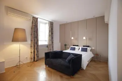 a bedroom with a large bed and a couch at La Kalsa Charming Maison in Palermo