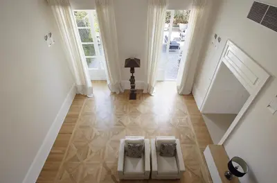 a hallway with two white chairs on the floor at La Kalsa Charming Maison in Palermo