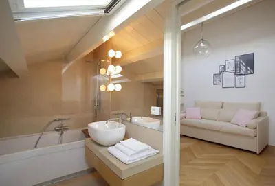 a bathroom with a sink and a tub and a couch at La Kalsa Charming Maison in Palermo