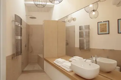 a bathroom with a sink and a shower and a mirror at La Kalsa Charming Maison in Palermo