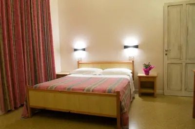 a bedroom with a bed with two pillows at B&B Castiglia in Palermo
