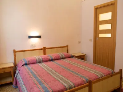 a bedroom with a bed and two night stands at B&B Castiglia in Palermo