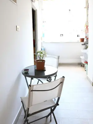 a table and a chair with a plant on it at Plumeria/Libertà in Palermo