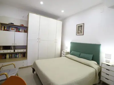 a bedroom with a bed and a white cabinet at Plumeria/Libertà in Palermo