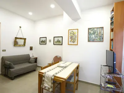 a living room with a couch and a table at Plumeria/Libertà in Palermo
