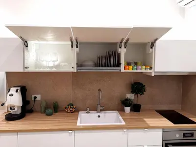 a kitchen with white cabinets and a sink at Betta splendens in Palermo