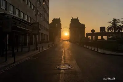 an empty street with the sunset in the background at Hostel Centro BASEMENT in Palermo