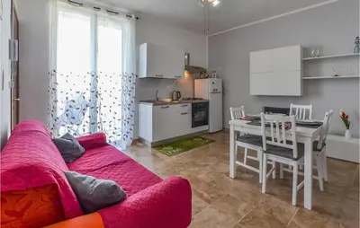 a living room with a couch and a table and a kitchen at La Casa Sul Mare in Trappeto