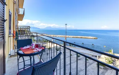 a balcony with a table and chairs and the ocean at La Casa Sul Mare in Trappeto