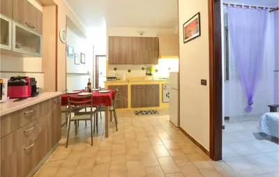 a kitchen with a red table and chairs in a room at Beautiful Apartment In Palermo Pa in Sferracavallo