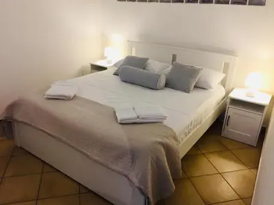 a bedroom with a large bed with two night stands at La Dimora della Cattedrale in Palermo