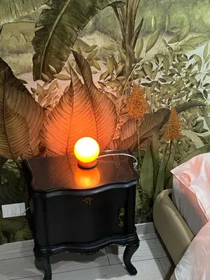 a lamp on a table in front of a wall at Palazzo Liberty in Monreale