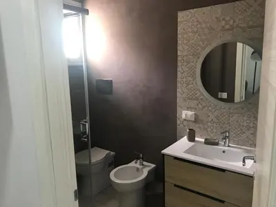 a bathroom with a sink and a toilet and a mirror at Palazzo Liberty in Monreale