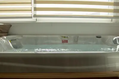 a tub filled with water in a room at Luxmarì Hotel & Spa in Castellammare del Golfo