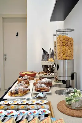 a table with a bunch of pastries and other foods at One in Palermo