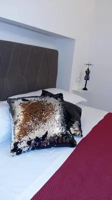 a bed with a black and gold pillow on it at San Francesco Rooms and Apartment with Terrace in Palermo Locazione Turistica in Palermo