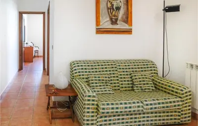 a living room with a green couch and a table at Mages in Casteldaccia