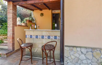 two chairs and a bar on a patio at Mages in Casteldaccia